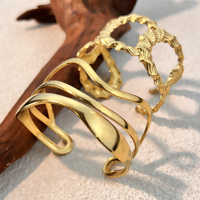 1 pulsera de acero inoxidable de forma irregular en color dorado. h5 Imagen2